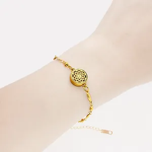 Detailed macro view of a 12mm gold stainless steel aromatherapy bracelet worn on a wrist