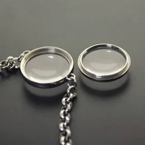 Macro view of stainless steel floating locket bracelet showing curved glass detail