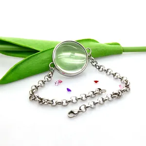Detailed close-up view of a stainless steel floating locket bracelet with curved glass