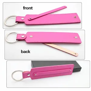 Close-up detail of the front and back of a pink faux leather swiveling keychain