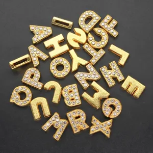 Close-up of 8mm gold alloy alphabet beads with rhinestones for DIY jewelry making