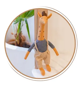 Detailed view of handmade stuffed giraffe doll wearing striped shirt and linen overalls