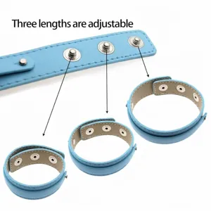 Detailed view of the light blue faux leather wristband with adjustable snap buttons