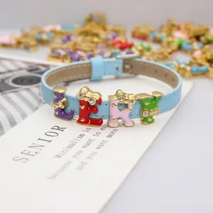 Close-up of 8mm rhinestone letter charms J, E, K, Y on a light blue faux leather strap