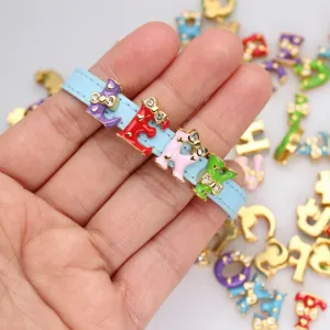 Detailed macro view of 8mm rhinestone bowknot enamel alphabet charms for DIY jewelry