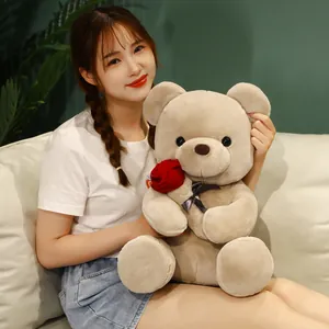Plush beige teddy bear holding a red rose, ideal Valentine's Day gift for room decor