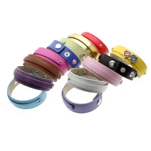 Detailed view of multi-colored faux leather double-layered wristbands with metal snap buttons.