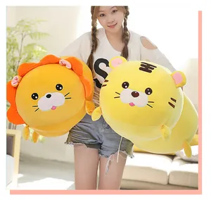 Asian girl holding large cute lion and tiger plush pillows in a bright indoor room