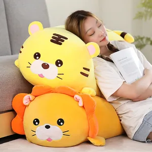 Detail view of large soft plush tiger and lion pillows with a girl resting comfortably