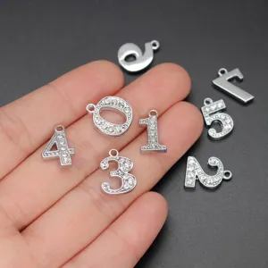 Detailed macro view showing 15mm silver numeric charms with sparkling rhinestones.