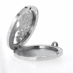 Macro view of an open 38mm stainless steel aromatherapy locket with tree pattern