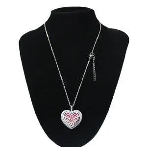 Detailed view of 30mm stainless steel heart aromatherapy diffuser locket on black bust