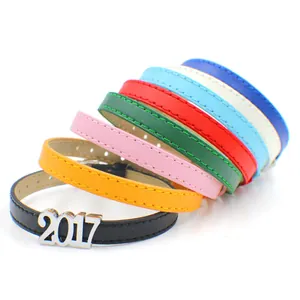 Detail of 8mm colorful PU leather bracelets with silver 2017 charm in stacked arrangement