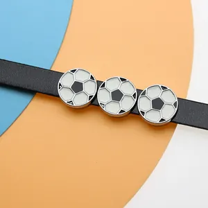Macro view of soccer ball enamel charms sliding on a black 8mm wristband