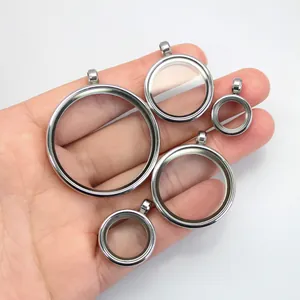 Handheld comparison of five stainless steel double-sided glass Gau box pendants in varied sizes