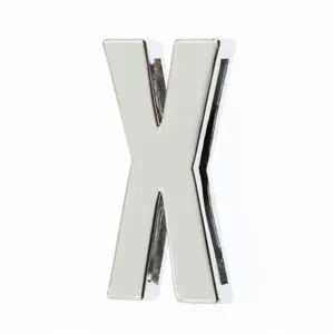 Macro detail of a 30mm silver chrome 3D letter X DIY metal accessory for bags and clothing