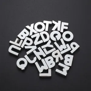 Detailed macro view of shiny 8mm chrome alphabet beads for custom DIY jewelry making projects
