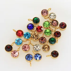 Close-up of 6mm colorful birthstone charms with gold stainless steel bezels for DIY crafts