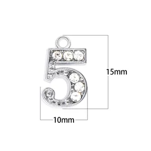 Close-up detail showing the 15mm by 10mm dimensions of the rhinestone number 5 pendant.