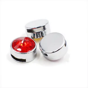 Macro detail of 8mm silver slide charm bead with red faceted crystal stone