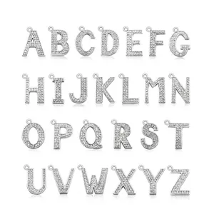Close-up detail of 26 silver alloy alphabet pendants with rhinestones for DIY jewelry making