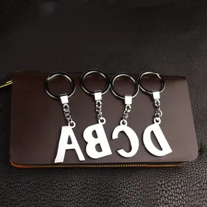 Close-up detail of silver alloy alphabet letter charms A-D for DIY luggage and keychains