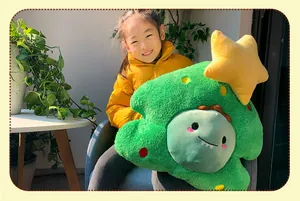 Happy young girl holding a soft plush Christmas tree pillow with star decoration