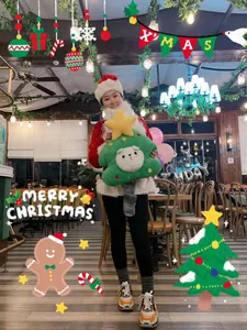 Cute green Christmas tree plush toy with cartoon animal face and star top