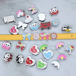 Detailed view of cartoon enamel slide charms on an 8mm yellow leather bracelet strap.