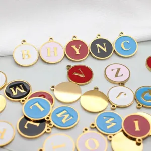Close-up view of colorful round enamel alphabet letter charms in gold plated stainless steel