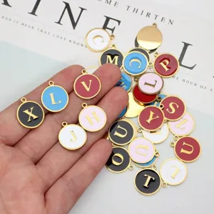 Close-up of colorful round enamel alphabet charms for DIY jewelry making
