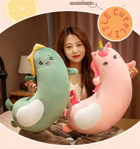 Lifestyle view of curved long plush body pillows in dinosaur and unicorn designs for sleep