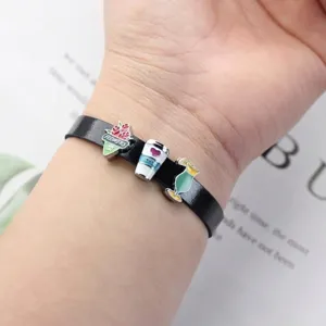 Detailed shot of black 8mm leather wristband with colorful alloy flowers and coffee slide charms