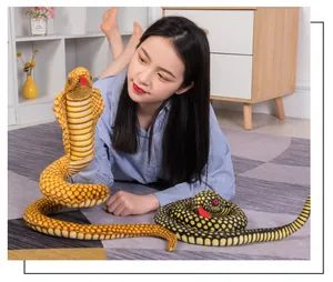 Realistic cobra and python plush snakes with a model in a cozy home setting.