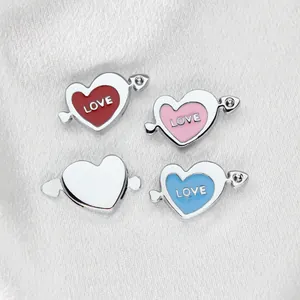 High-quality macro view of 8mm heart charms with rhinestone and enamel 'LOVE' lettering