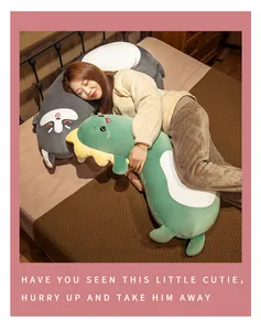 Asian woman sleeping with soft green dinosaur and grey cat long plush body pillows