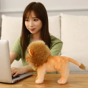Realistic cute plush lion doll toy standing on a wooden desk as home office decor.