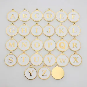 Collection of twenty-six round alphabet charms in gold finish with white enamel drip design