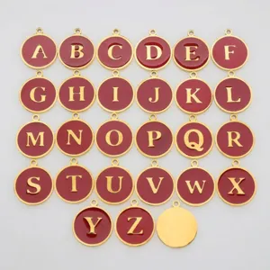 Detail showing the full set of 26 red enamel and gold stainless steel alphabet charms.