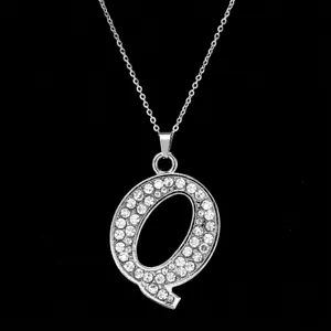 Detailed close-up of a silver-toned crystal-encrusted alphabet letter Q pendant charm