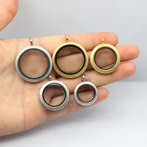 Detailed view of frosted stainless steel round Gawu box pendants in gold and silver colors
