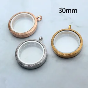 Detailed macro view showing three 30mm frosted stainless steel circular glass locket pendants.