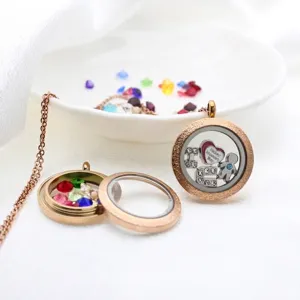 Close-up view of stainless steel locket pendant with colorful crystal stones inside.