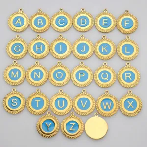 Group view of round gold-tone stainless steel alphabet pendants with blue enamel detail.