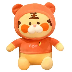 Süßes Tiger-Plüschtier mit orangefarbenem Kapuzenpullover, Stickerei und Bananen-Symbol