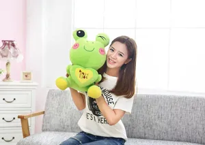 Detailed view of a cute green frog plush toy held by a model in a cozy room