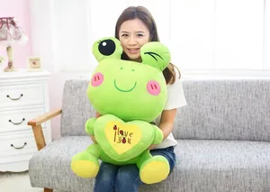 Detailed view of large green plush frog doll holding a heart with I love you embroidery