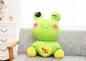 Cute green frog plush toy holding a yellow heart with 'I love you' embroidery detail.