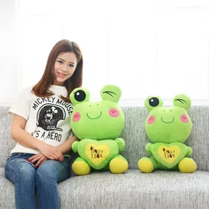 Adorable green cartoon plush frog with 'I love you' heart message held by a model