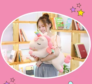 Large soft rainbow unicorn plush toy pillow held by a girl in a home library room